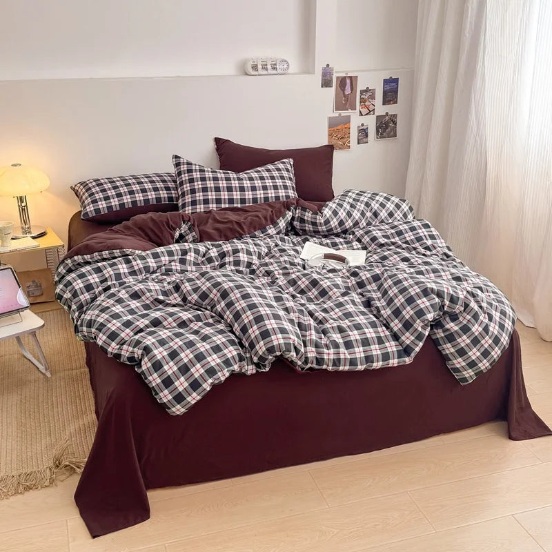 Burgundy Tartan plaid bedding set with solid burgundy reverse styled on a bed