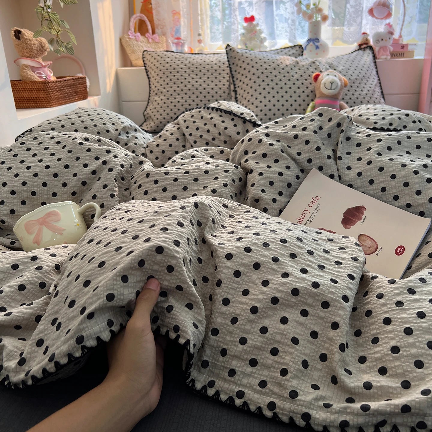Ivory Black Dot polka dot bedding set with braided trim styled on a bed