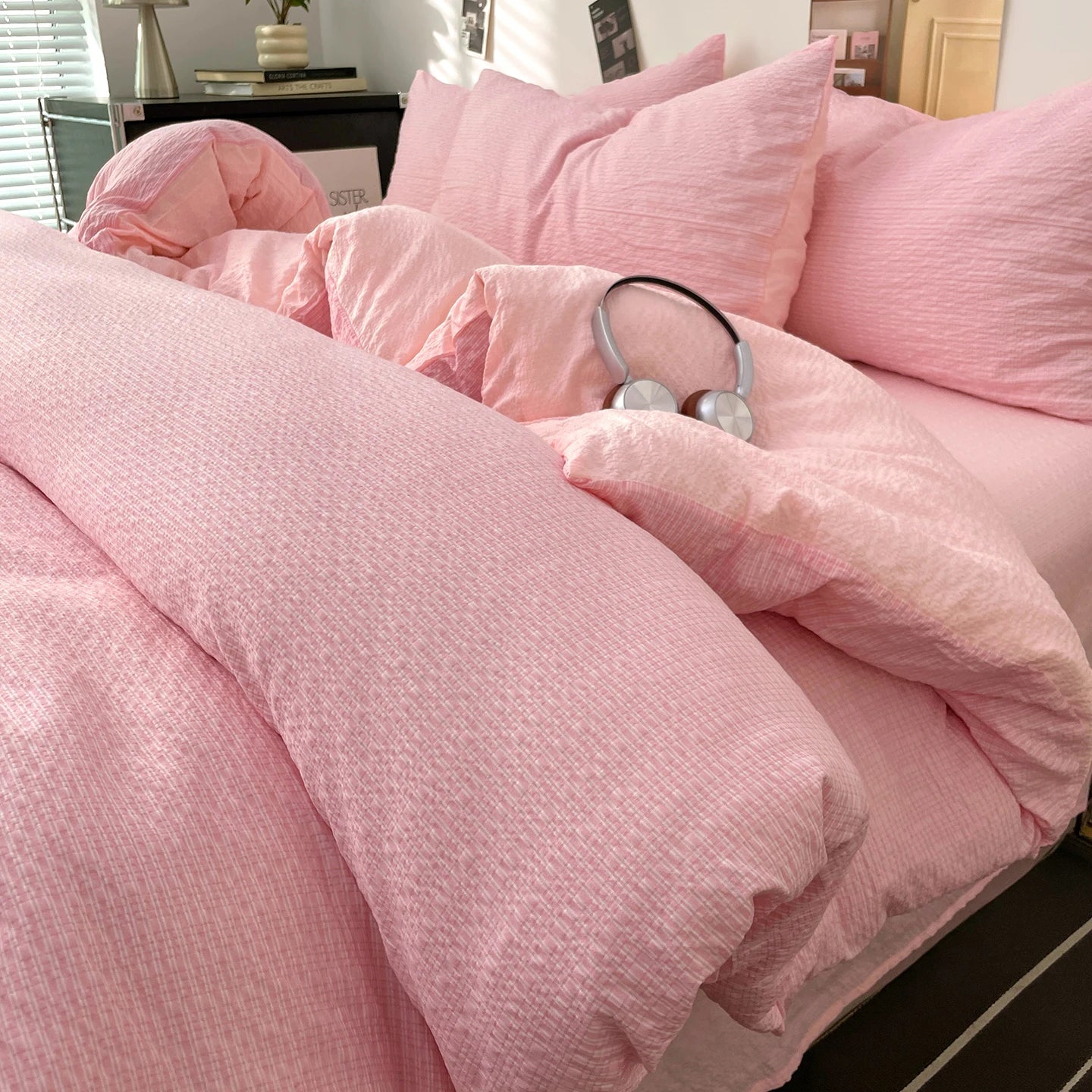 Blush Pink textured stripe bedding set styled on a bed with matching pillows