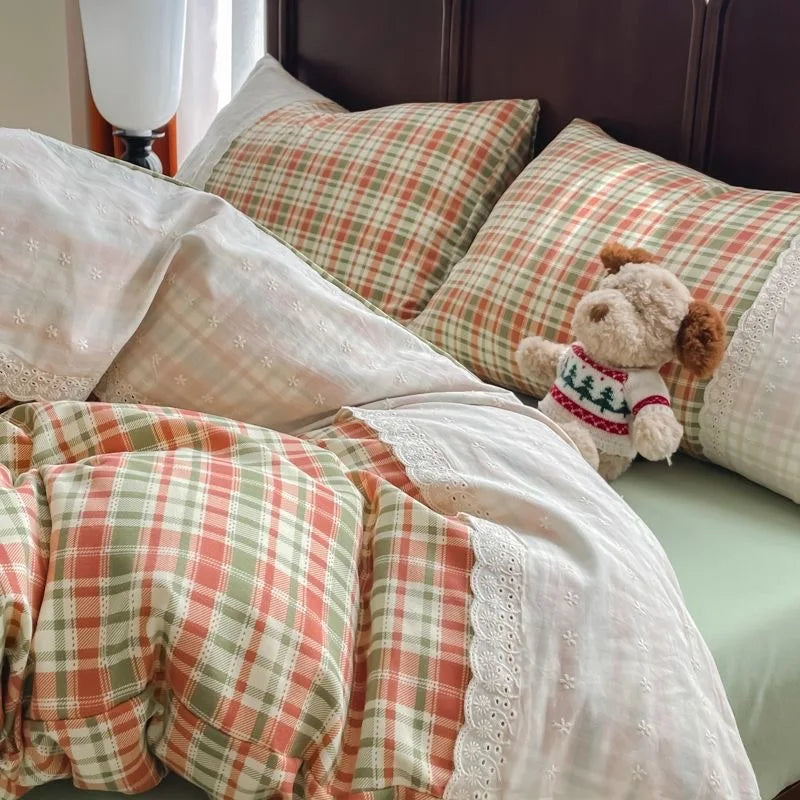 Coral Sage Check plaid bedding set with white lace trim styled on a bed