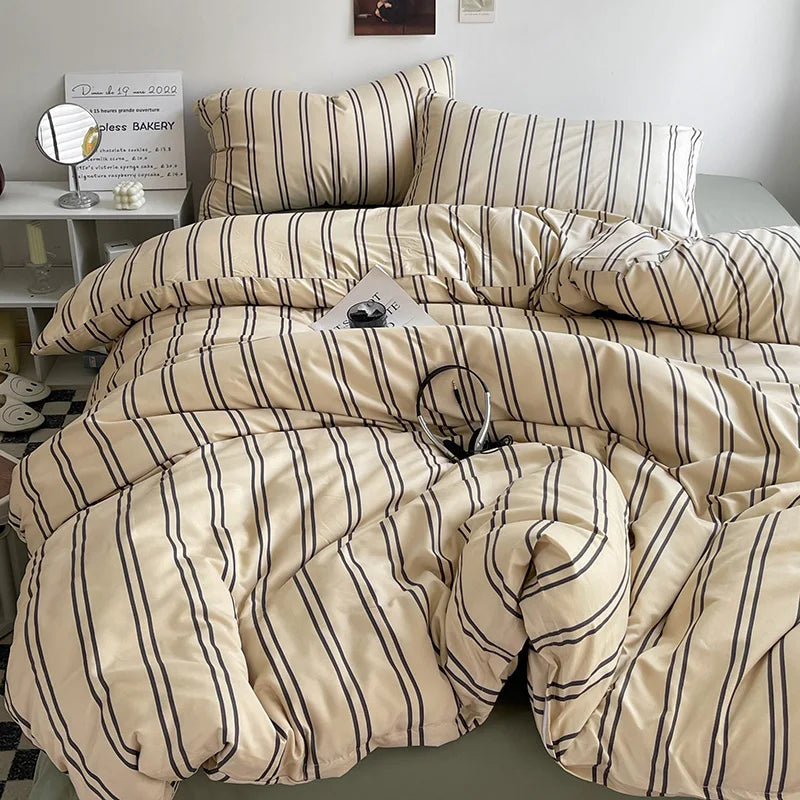 cream and beige striped cotton bedding set on bed