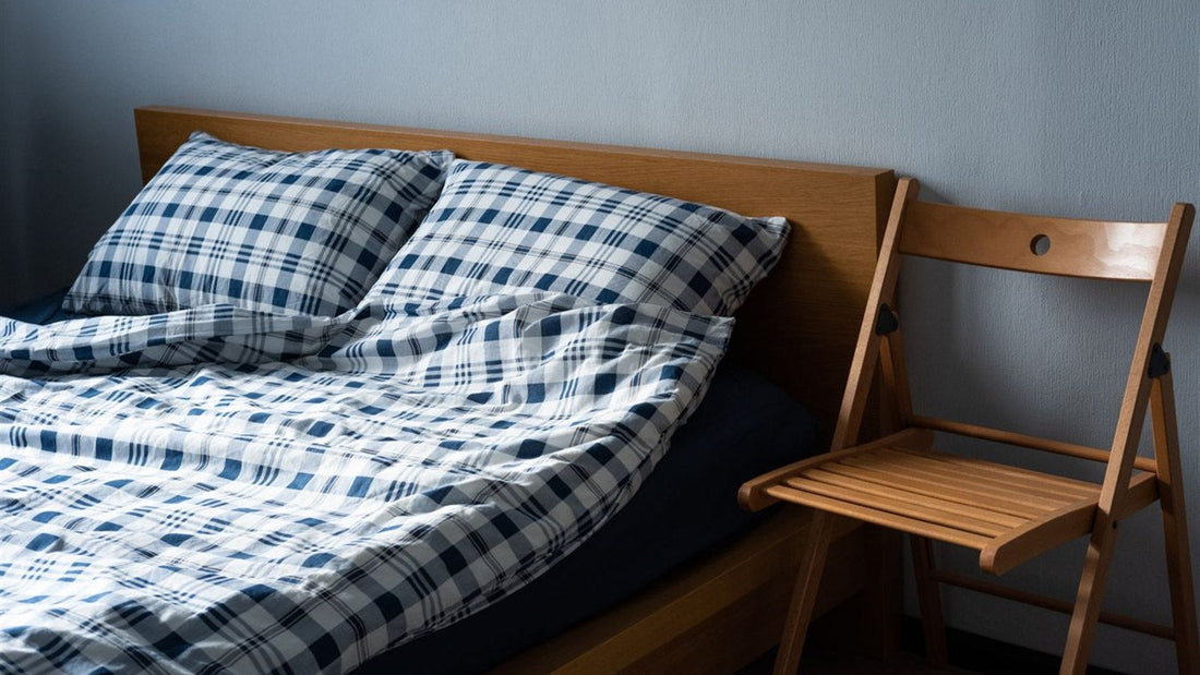Bed dressed with a stitched, patterned quilt-style cover