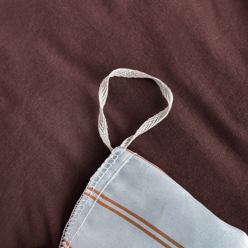 Blue striped bedding set with thin lines on white and a dark brown solid reverse