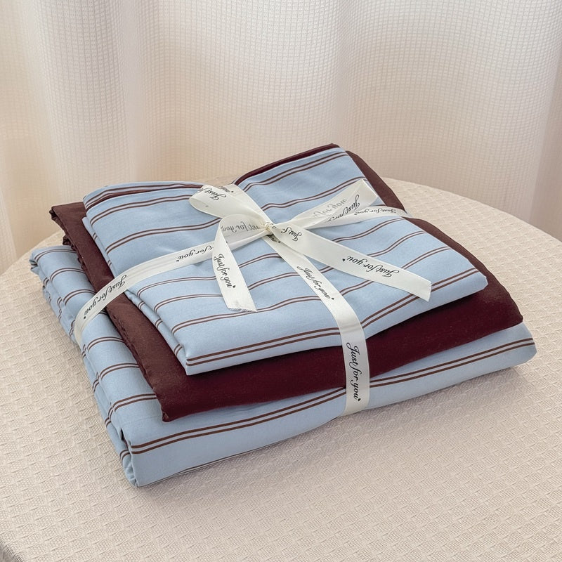 Blue striped bedding set with thin lines on white and a dark brown solid reverse