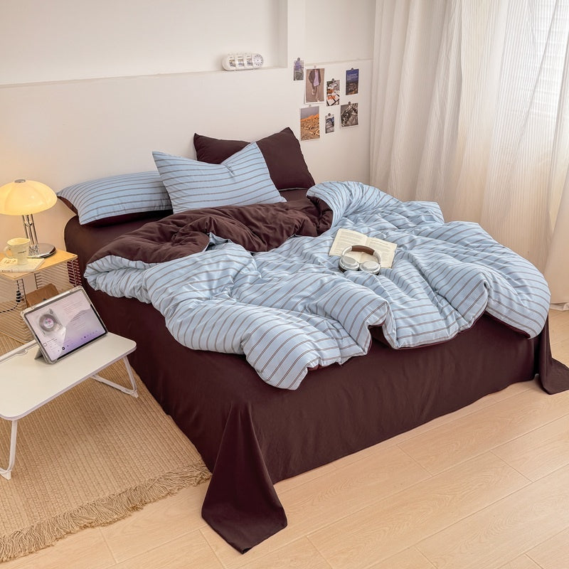 Blue striped bedding set with thin lines on white and a dark brown solid reverse