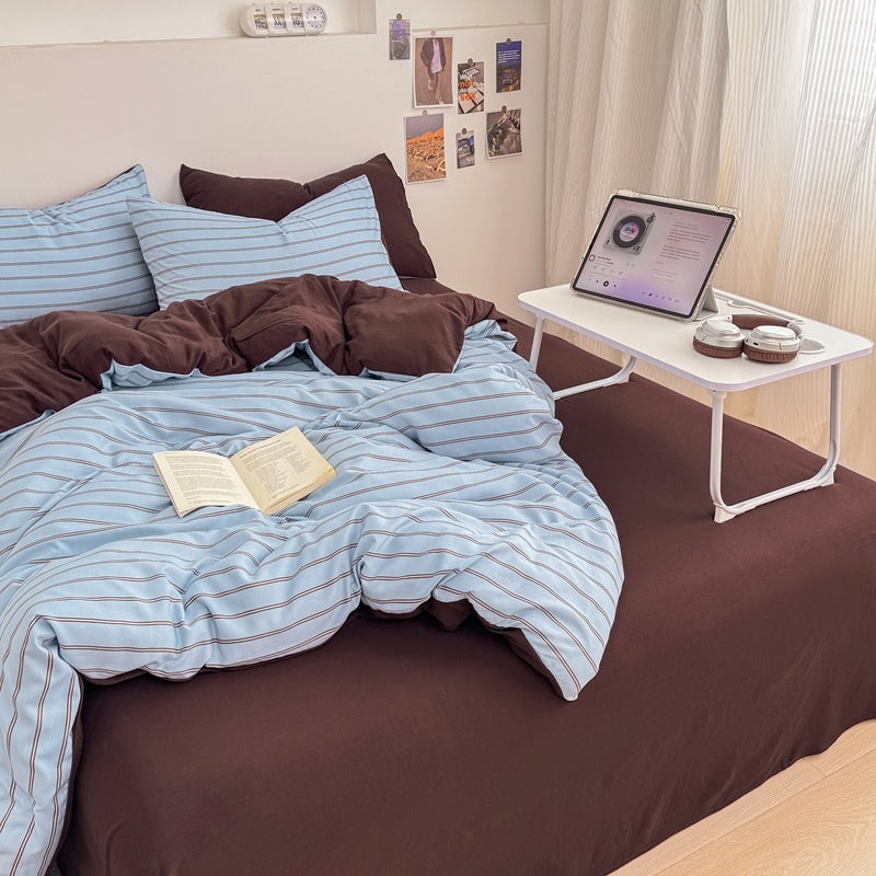 Blue striped bedding set with thin lines on white and a dark brown solid reverse