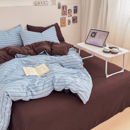 Blue striped bedding set with thin lines on white and a dark brown solid reverse