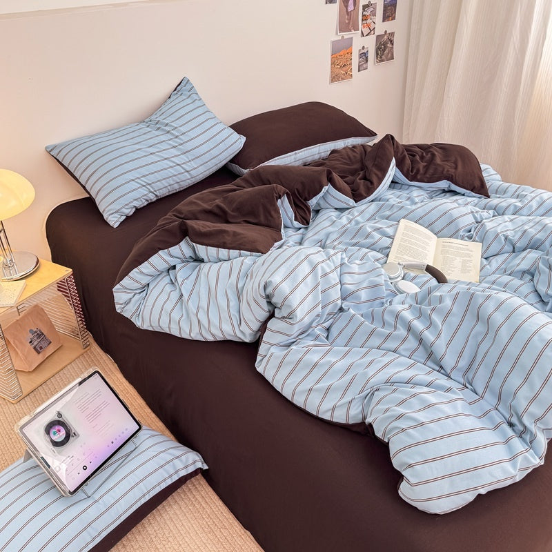 Blue striped bedding set with thin lines on white and a dark brown solid reverse