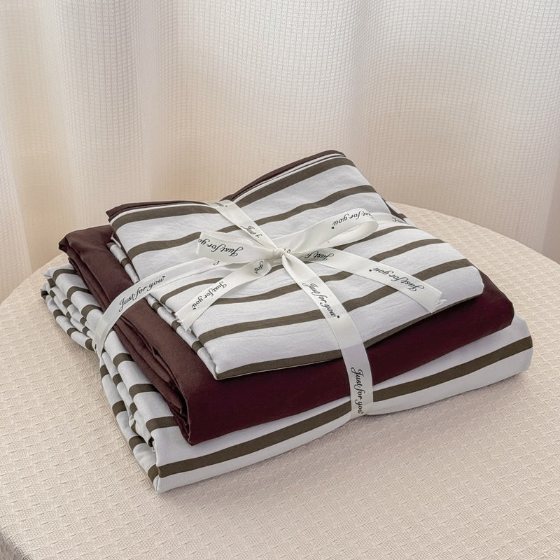 Olive green striped bedding set on white with deep brown solid sheet and reverse