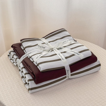 Olive green striped bedding set on white with deep brown solid sheet and reverse