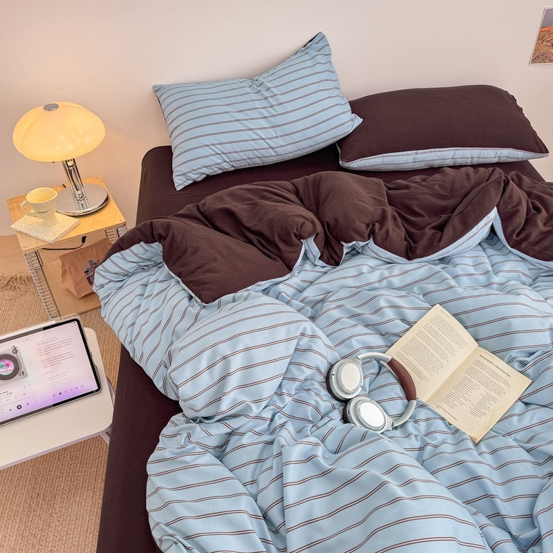 Blue striped bedding set with thin lines on white and a dark brown solid reverse