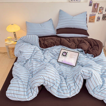 Blue striped bedding set with thin lines on white and a dark brown solid reverse