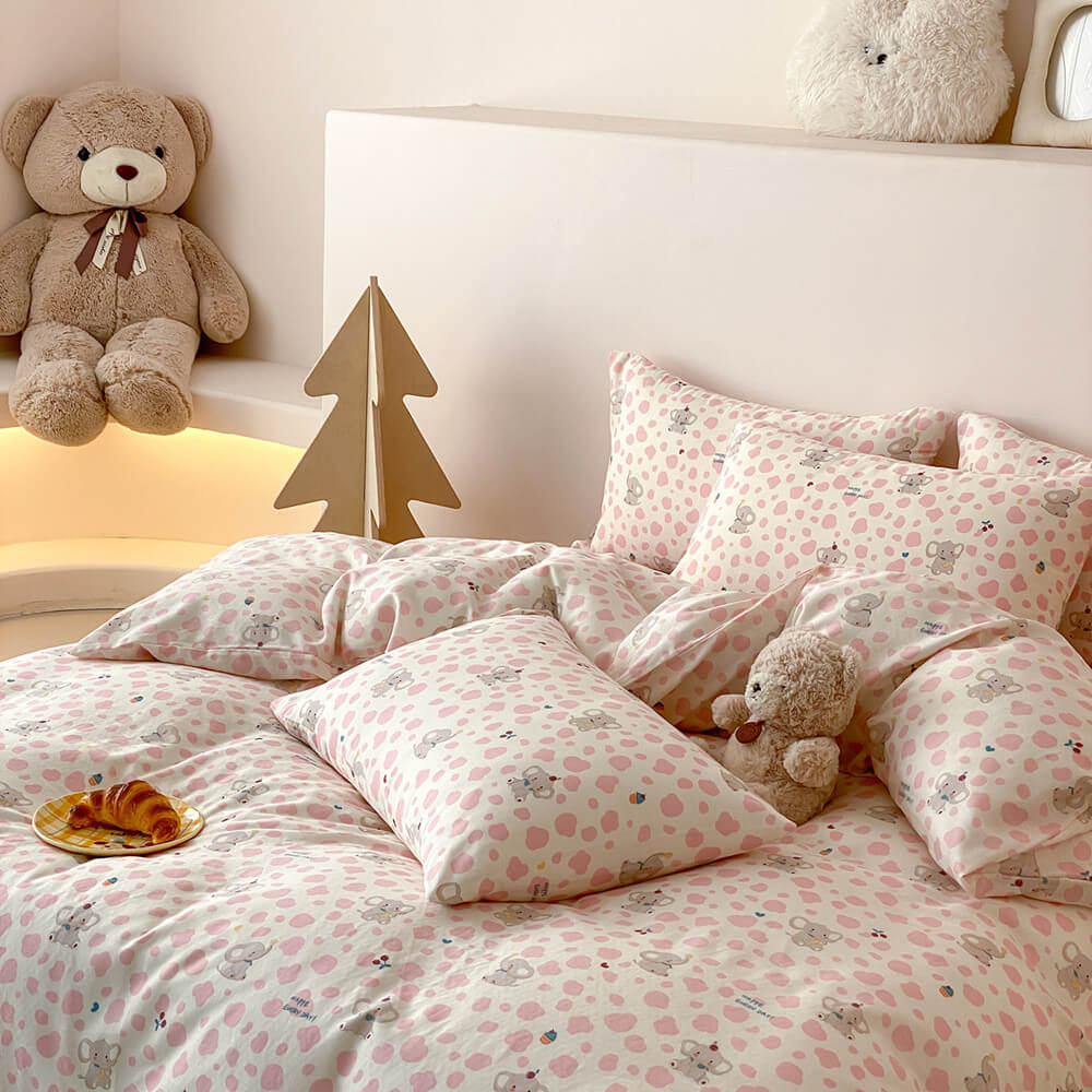 Pippa Elephant Spot Cotton Bedding Set - pink-spotted pillowcases stacked on the bed - WhisperLinens