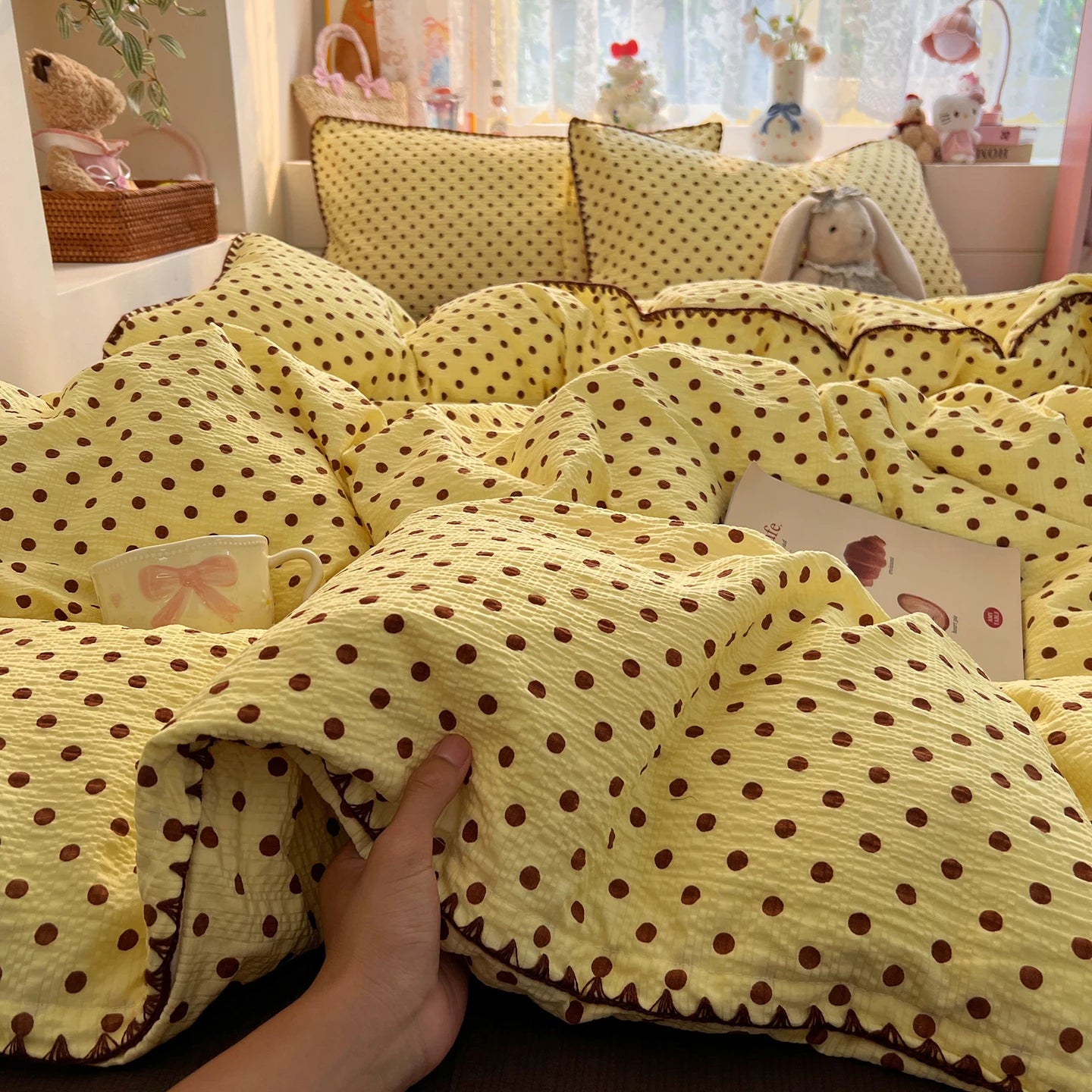 Butter Cocoa Dot polka dot bedding set with braided trim styled on a bed