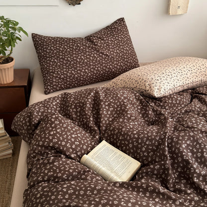 Cocoa Ditsy floral bedding set with cream floral reverse styled on a bed