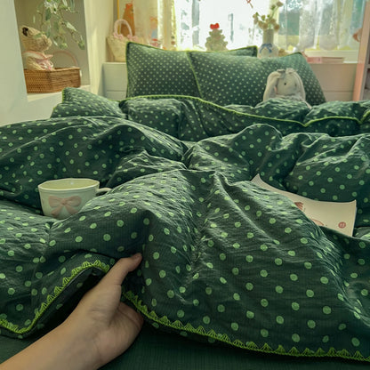 Forest Green Dot polka dot bedding set with braided trim styled on a bed