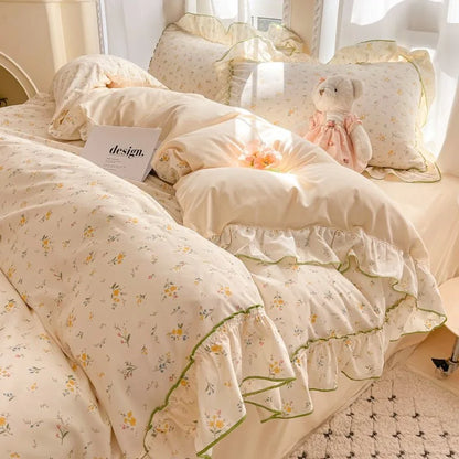 Buttercup Ditsy floral ruffle bedding set with green trim styled on a bed