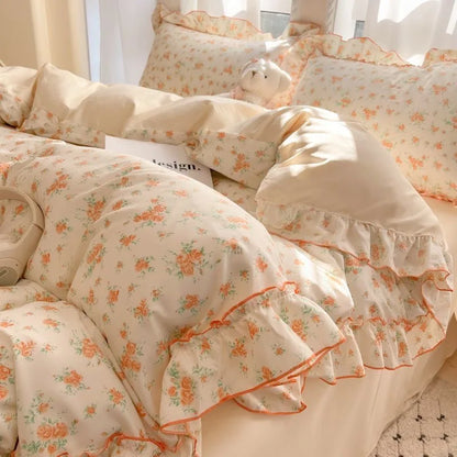 Coral Rose floral ruffle bedding set with coral trim styled on a bed