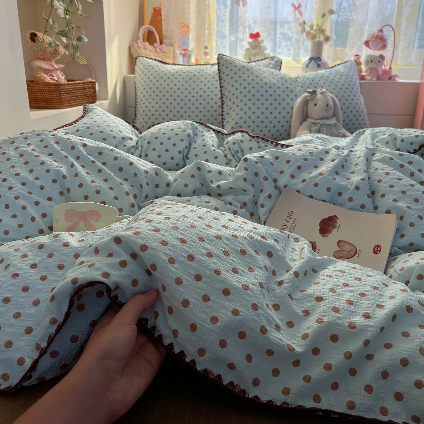 Blue Cocoa Dot polka dot bedding set with braided trim styled on a bed