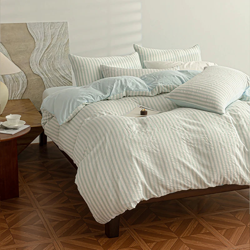 Sky Blue seersucker bedding set styled on a bed with matching pillows