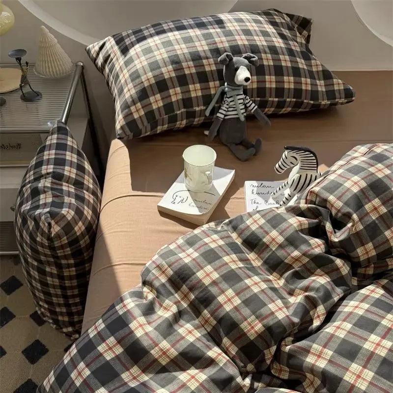 Forest Tartan plaid bedding set in green and red check styled on a bed