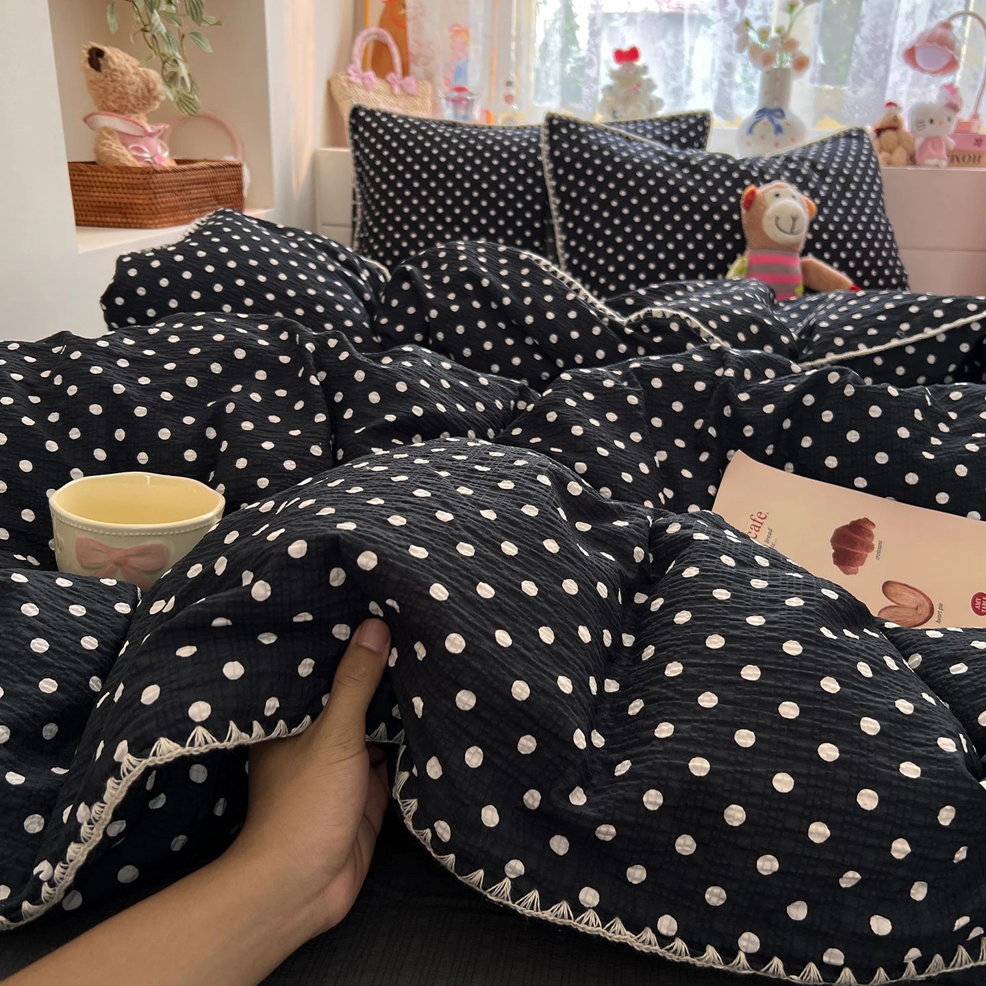 Black Cream Dot polka dot bedding set with braided trim styled on a bed