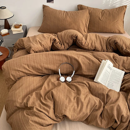Caramel Brown pinstripe bedding set styled on a bed with matching pillows