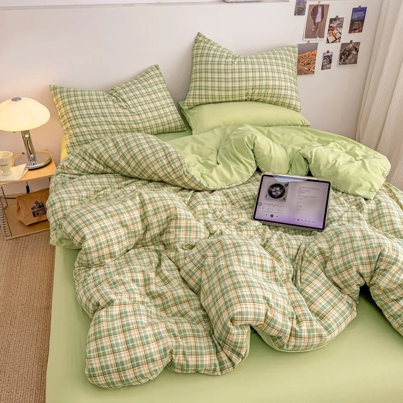 Matcha Green plaid bedding set with solid green reverse styled on a bed