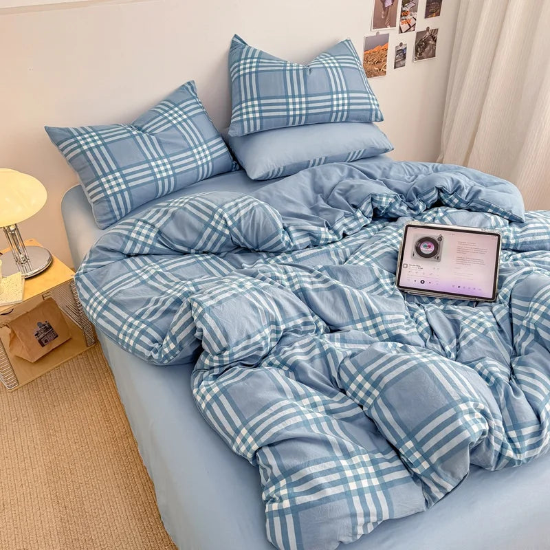 Sky Blue plaid bedding set with solid blue reverse styled on a bed