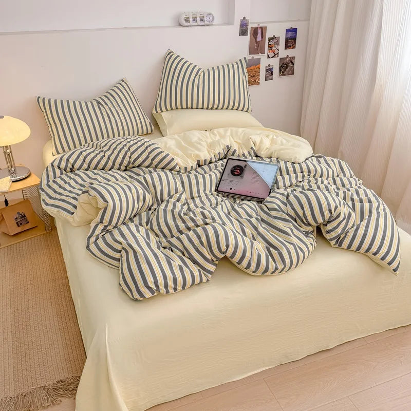 Harbor Cream striped bedding set with solid cream reverse styled on a bed