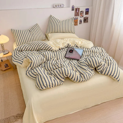 Harbor Cream striped bedding set with solid cream reverse styled on a bed