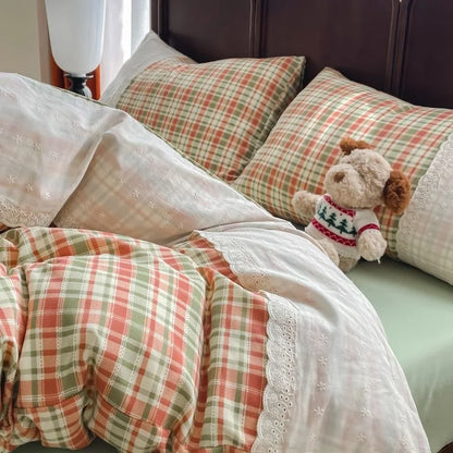 Coral Sage Check plaid bedding set with white lace trim styled on a bed