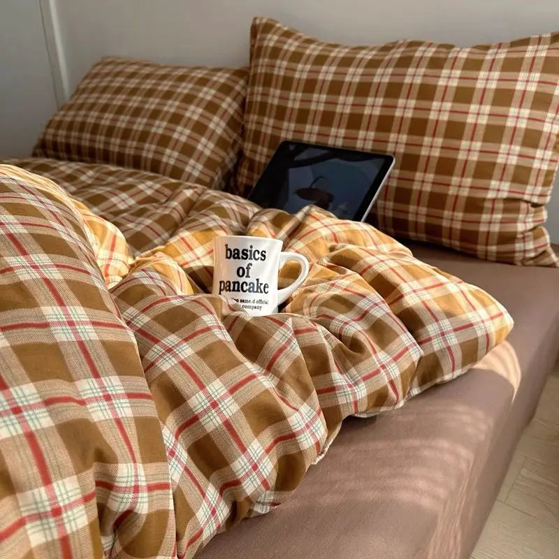 Mustard Tartan plaid bedding set in gold and red check styled on a bed