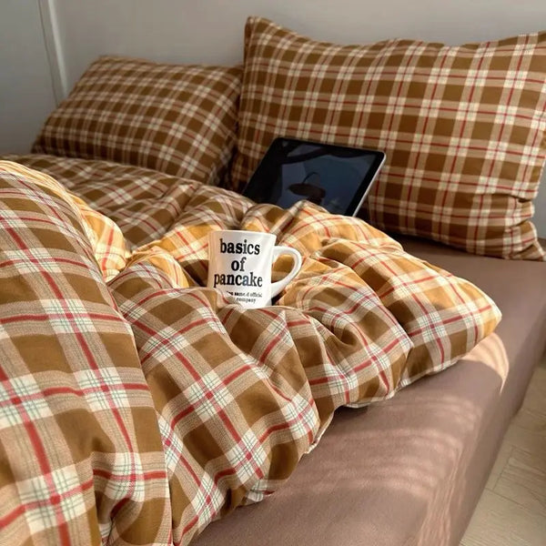 Mustard Tartan plaid bedding set in gold and red check styled on a bed