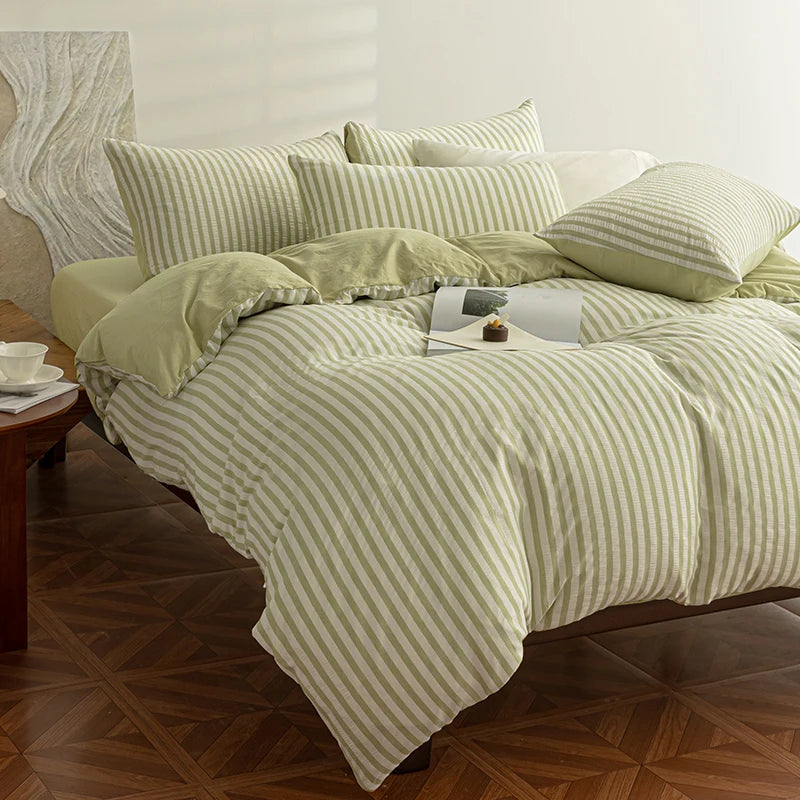 Sage Green seersucker bedding set styled on a bed with matching pillows