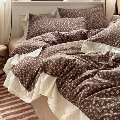 Cocoa Bloom floral ruffle bedding set with white lace trim styled on a bed