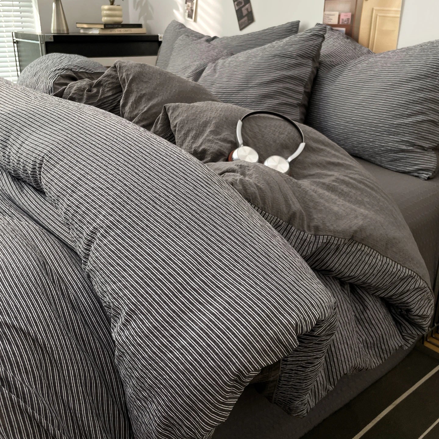 Charcoal Grey textured stripe bedding set styled on a bed with matching pillows