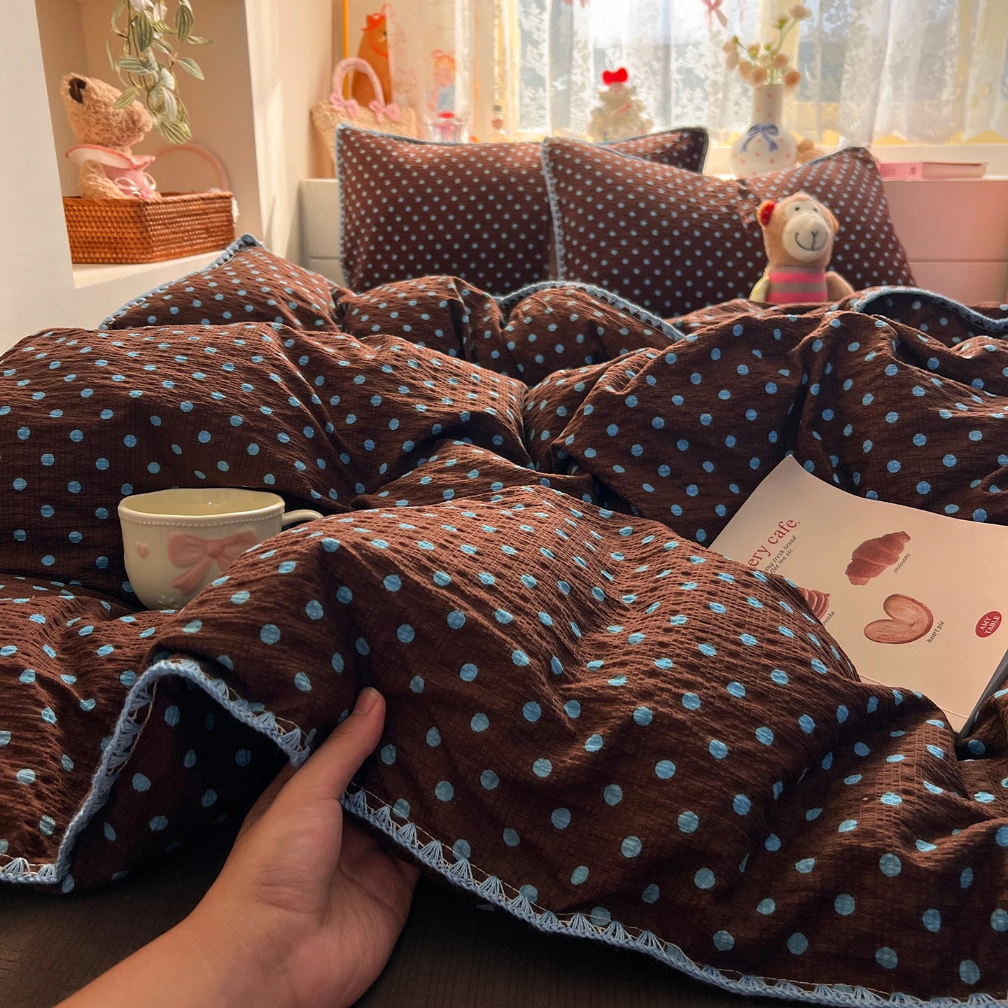 Cocoa Blue Dot polka dot bedding set with braided trim styled on a bed