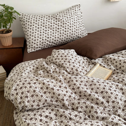 Vanilla Bloom ditsy floral bedding set with solid brown reverse styled on a bed