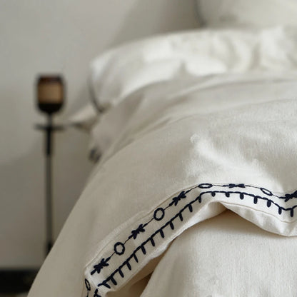 Close-up of embroidered edge on ivory linen cotton pillowcase