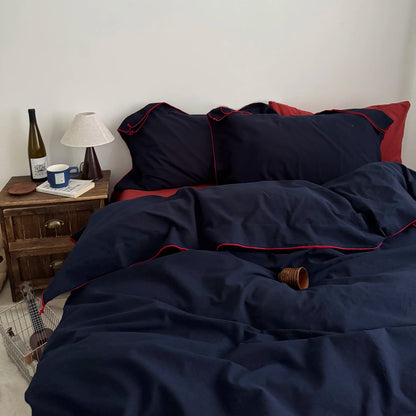 Navy cotton duvet cover set with red piping trim