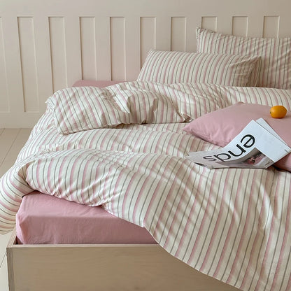 Light blue multicolor striped cotton bedding set styled with citrus