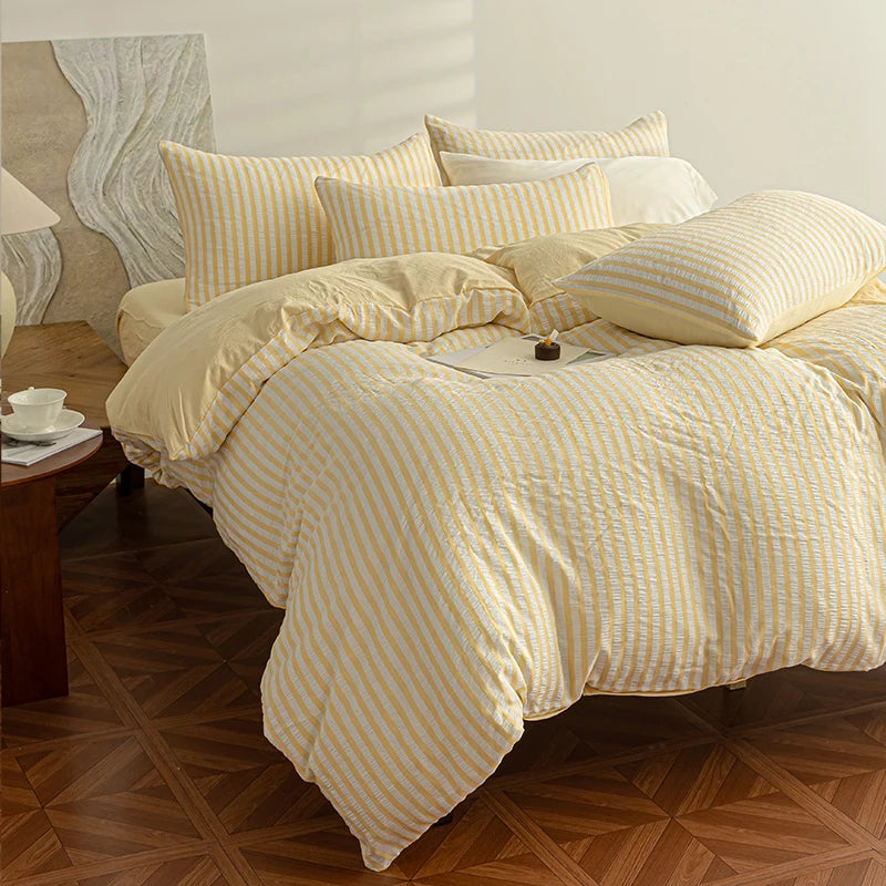 Butter Yellow seersucker bedding set styled on a bed with matching pillows