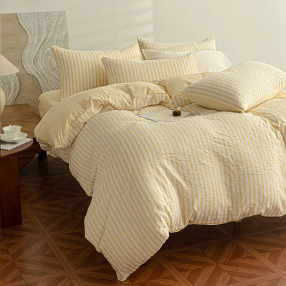 Butter Yellow seersucker bedding set styled on a bed with matching pillows