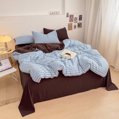 Blue striped bedding set with thin lines on white and a dark brown solid reverse