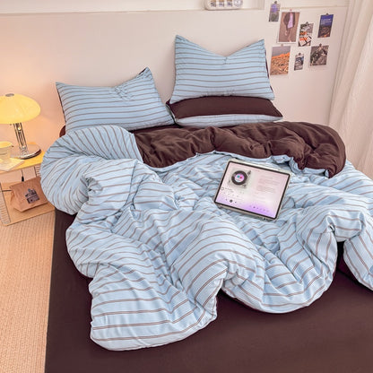 Blue striped bedding set with thin lines on white and a dark brown solid reverse
