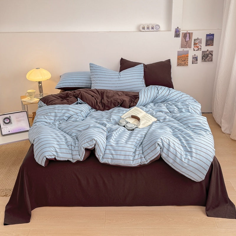 Blue striped bedding set with thin lines on white and a dark brown solid reverse