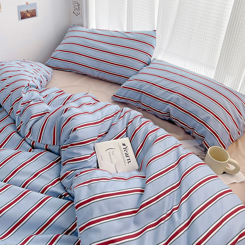 blue striped bedding set with red and white accents on soft blue fabric