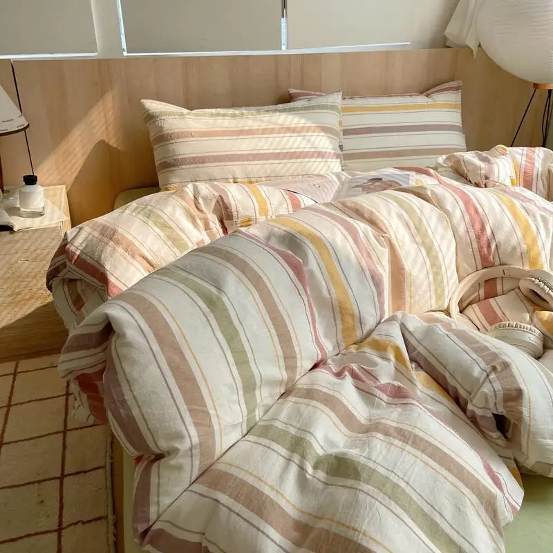 Cream bedding set with earthy autumn-inspired stripes in terracotta, ochre, and burgundy for cozy bedroom decor