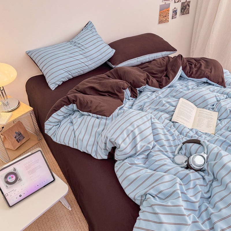 Blue striped bedding set with thin lines on white and a dark brown solid reverse